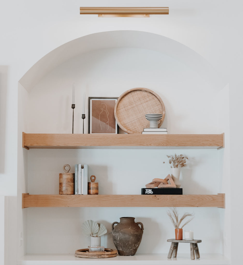 modern curved bookshelf with wooden floating shelves and vintage-inspired heirloom-quality decor for shelves | Hudson Blake - Lifestyle and Home